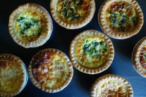 A variety of our 3" mini-quiches, include Bacon Broccoli Cheddar, Quiche Florentine, and Quiche Lorraine.