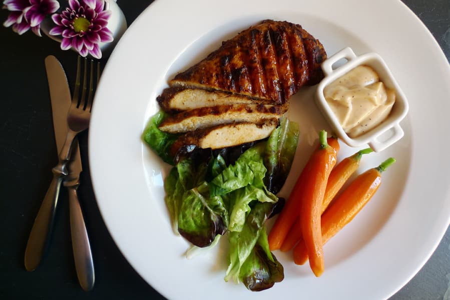 Ten Spice Chicken with Sweet Vinaigrette, a savory seasoned chicken breast served with a sweet vinaigrette sauce, shown served with carrots and salad.