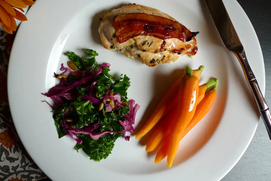 Bacon Topped Chicken Gorgonzola plated with sides.