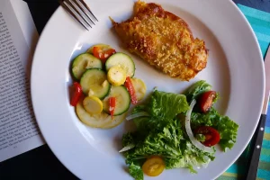 Baja Chicken shown plated with side dishes.