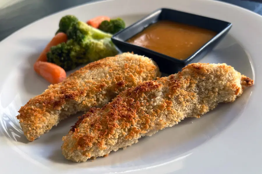 Bang Bang Chicken Fingers shown with Bang Bang sauce and mixed vegetable side dish.