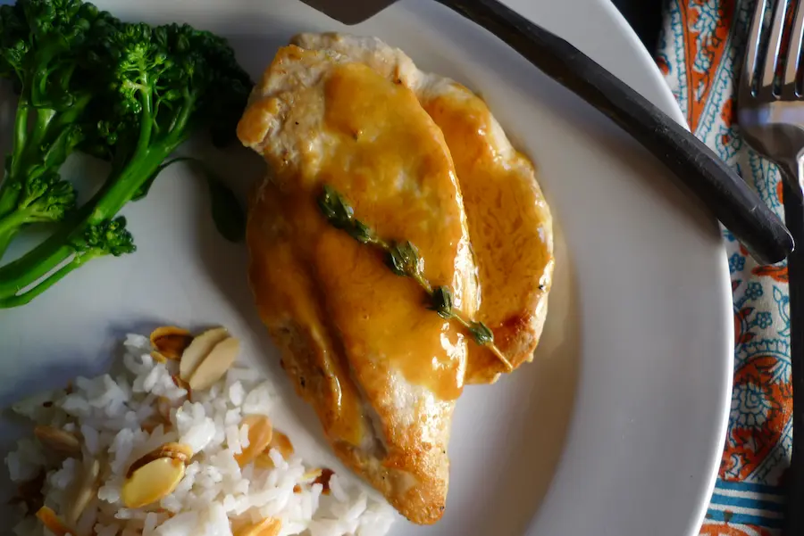 Chicken Cutlets with Citrus Beurre Blanc shown plated with side dishes.
