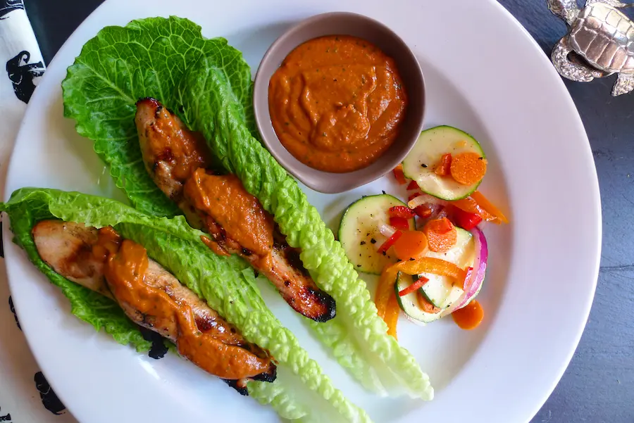 Thai Chicken Strips in Romaine Lettuce with Peanut Sauce. Shown plated with veggies.