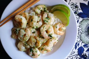 Cilantro Shrimp with Coconut Lime Rice garnished with a slice of lime.