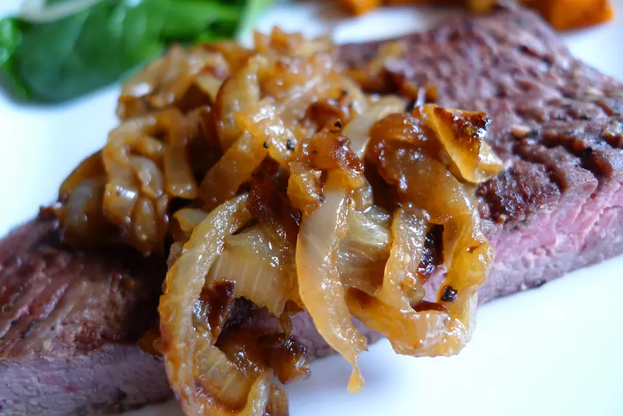 Flank Steak with Bourbon Onions shown plated with sides.