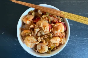 Kung Pao Shrimp over Rice shown with chopsticks.