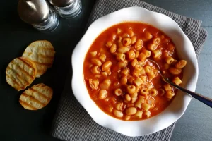 Pasta e Fagioli shown served with a side of toasted baguette slices.
