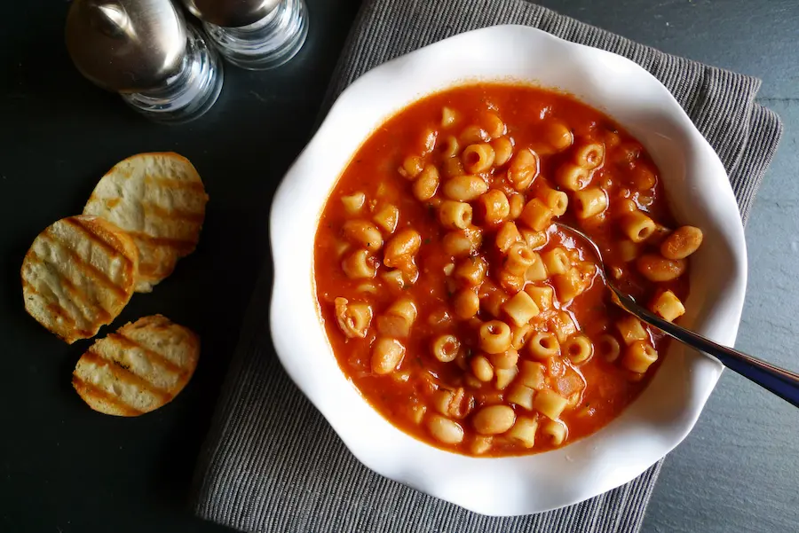 Pasta e Fagioli shown served with a side of toasted baguette slices.