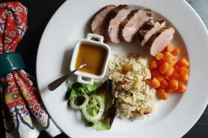 Pork Tenderloin with Apricot Sauce shown served with side dishes and salad.