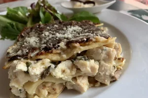 Rosemary Chicken Lasagna shown with a side salad.