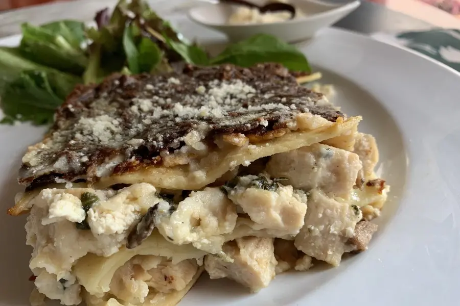 Rosemary Chicken Lasagna shown with a side salad.