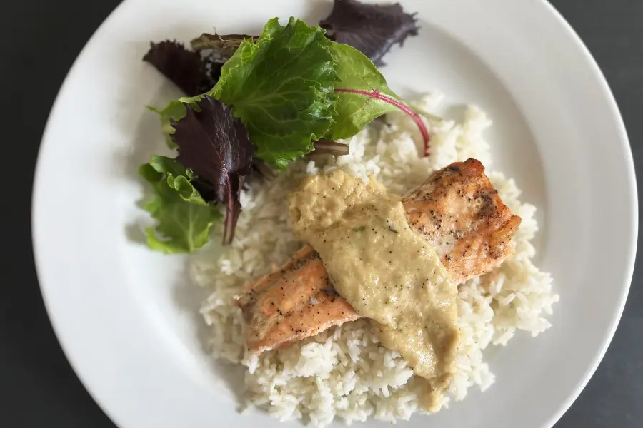 Salmon with Bearnaise sauce. Shown served over herbed rice with a side of salad.