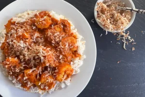 Shrimp Tikka Masala shown with toasted coconut topper.